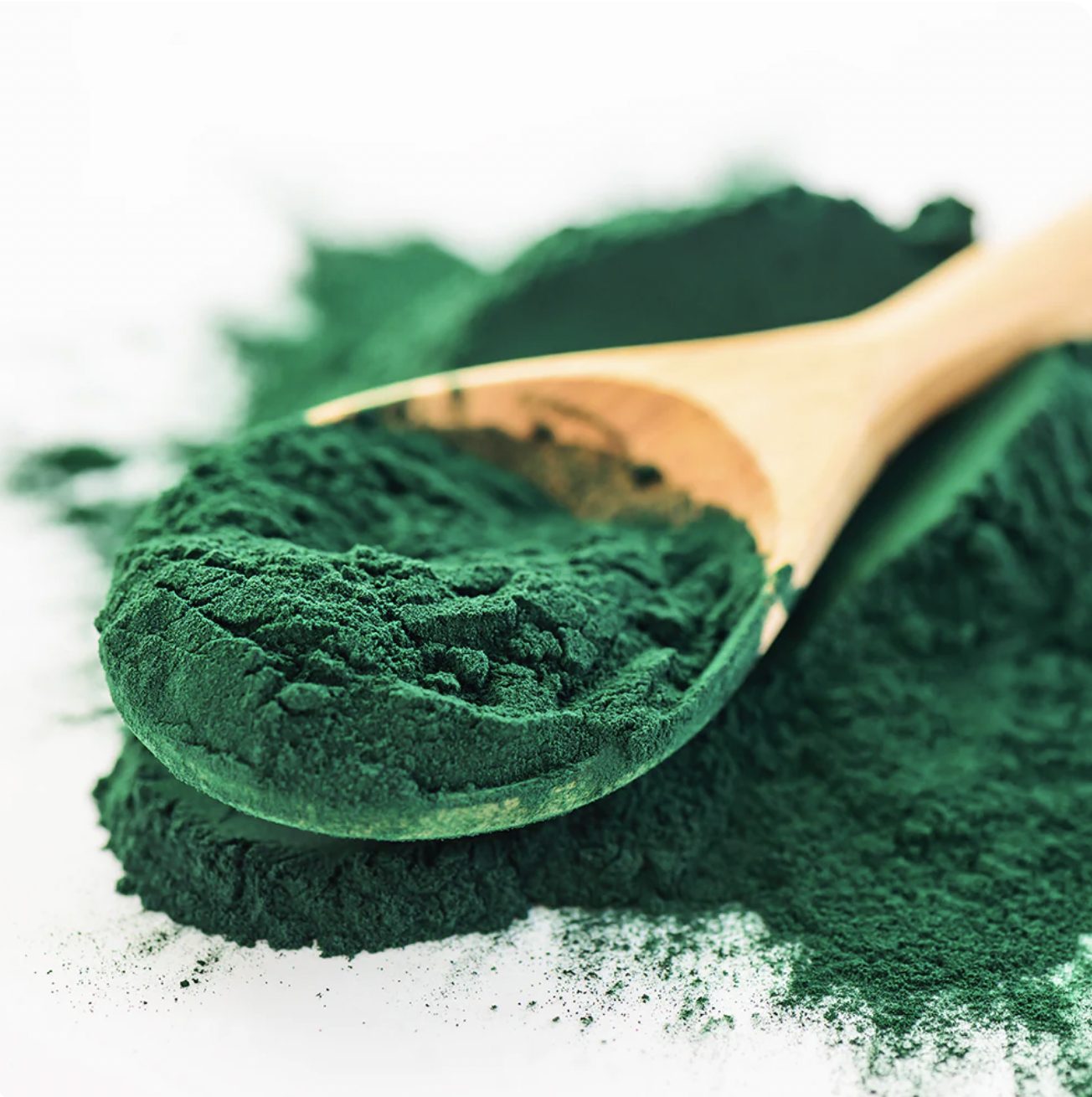 MB Superfoods Spirulina Powder Organic with a brown spoon, showcasing the vibrant green organic powder